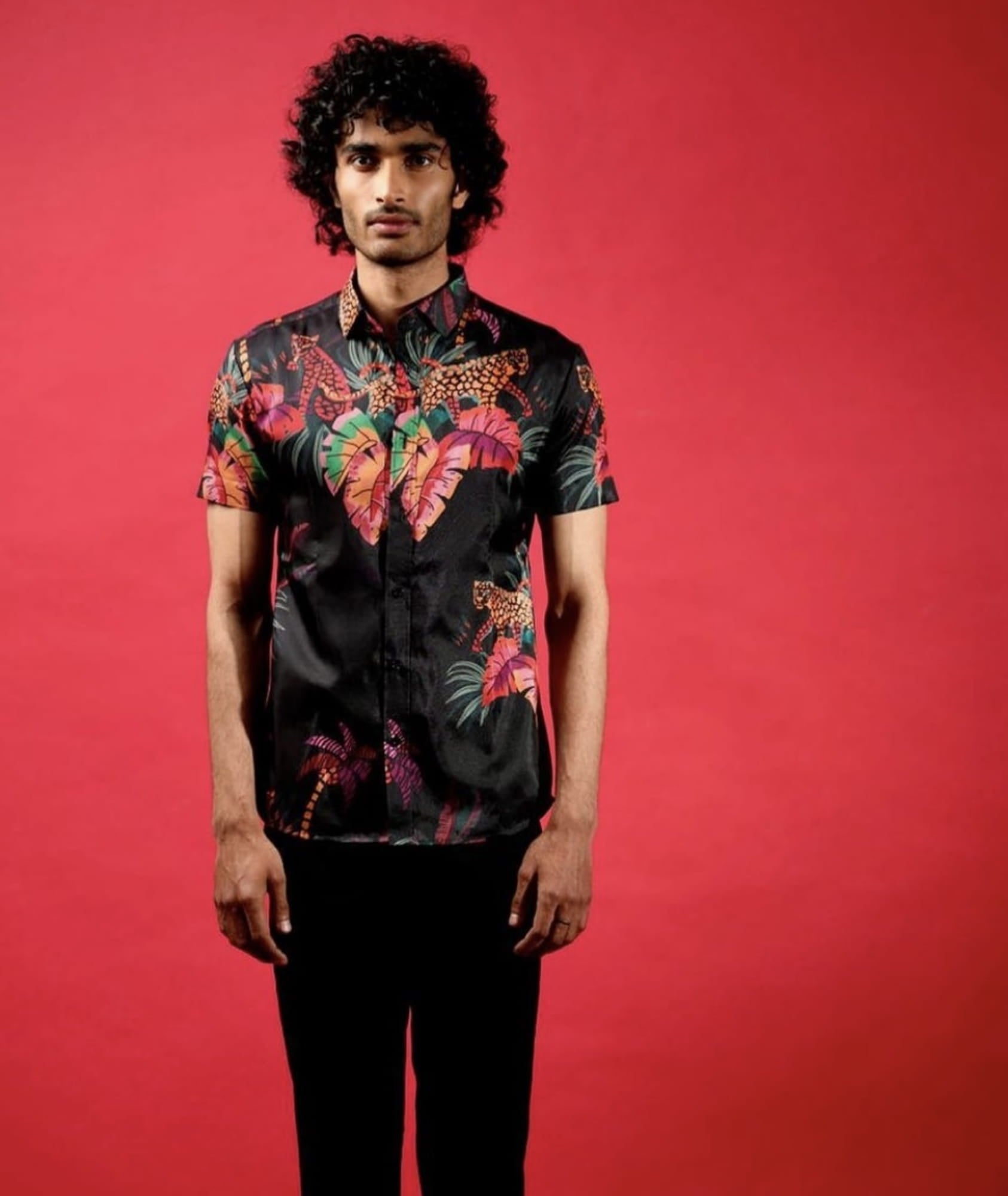 Man Wearing Black Tropical Print Shirt.