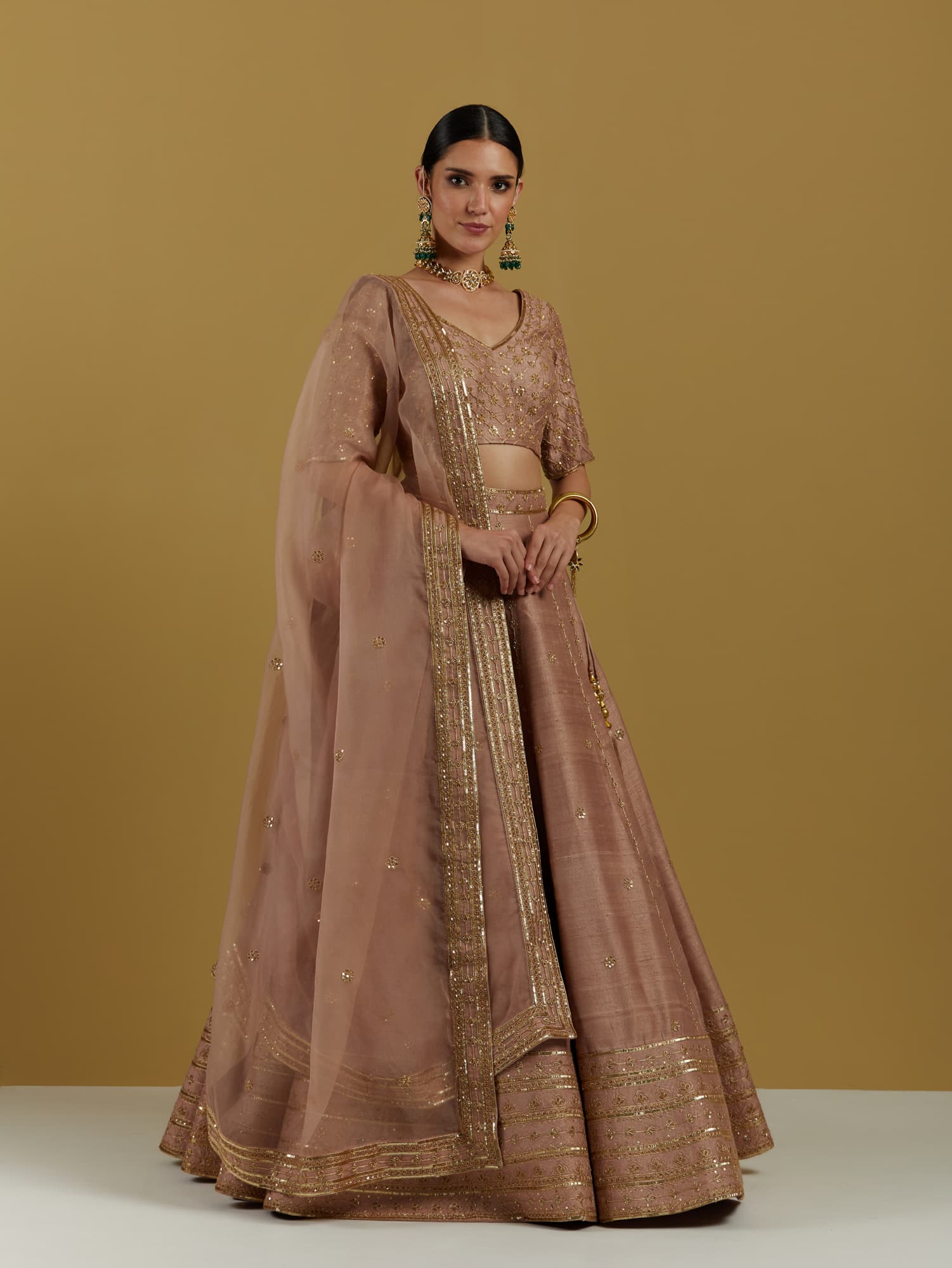 Women Wearing Pink Lehenga Set.